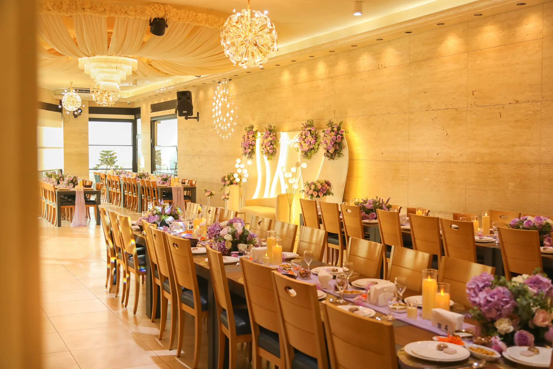 Long banquet tables under warm chandeliers