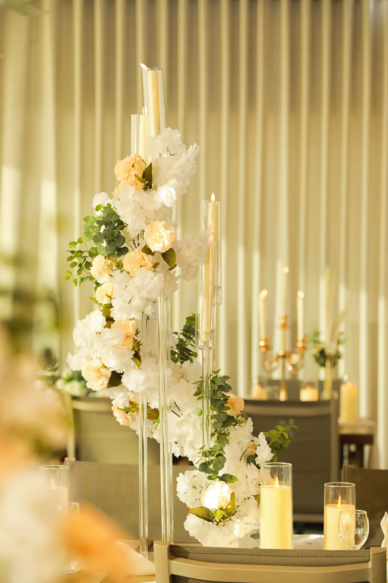 White floral candle stand beside the stage