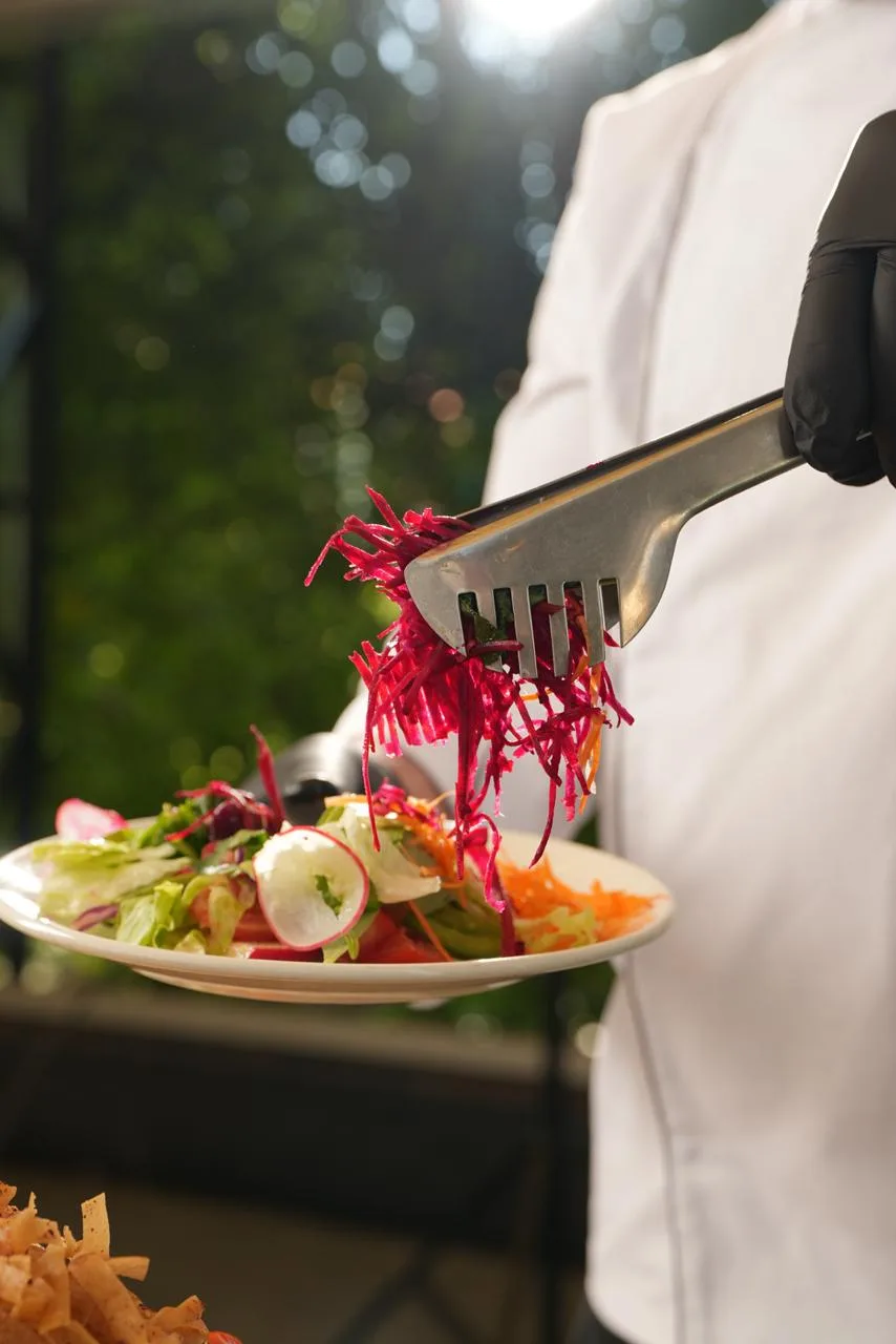 Beetroot salad served with tongs