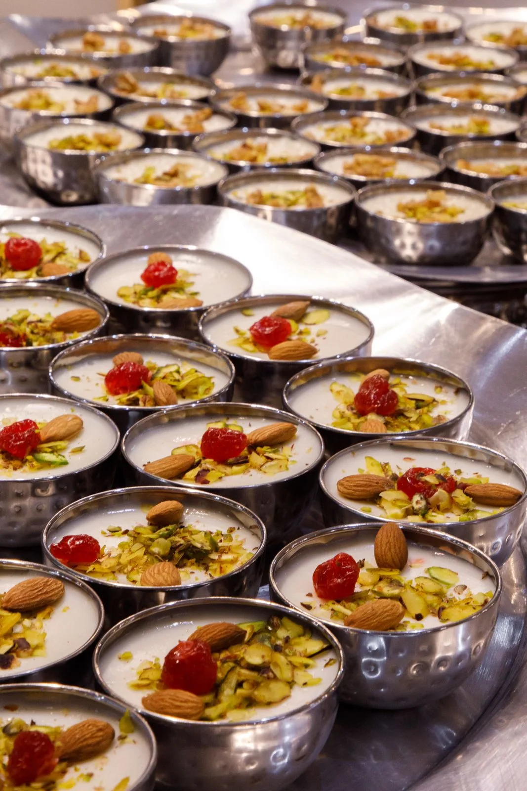 Rows of muhallabia desserts with pistachio