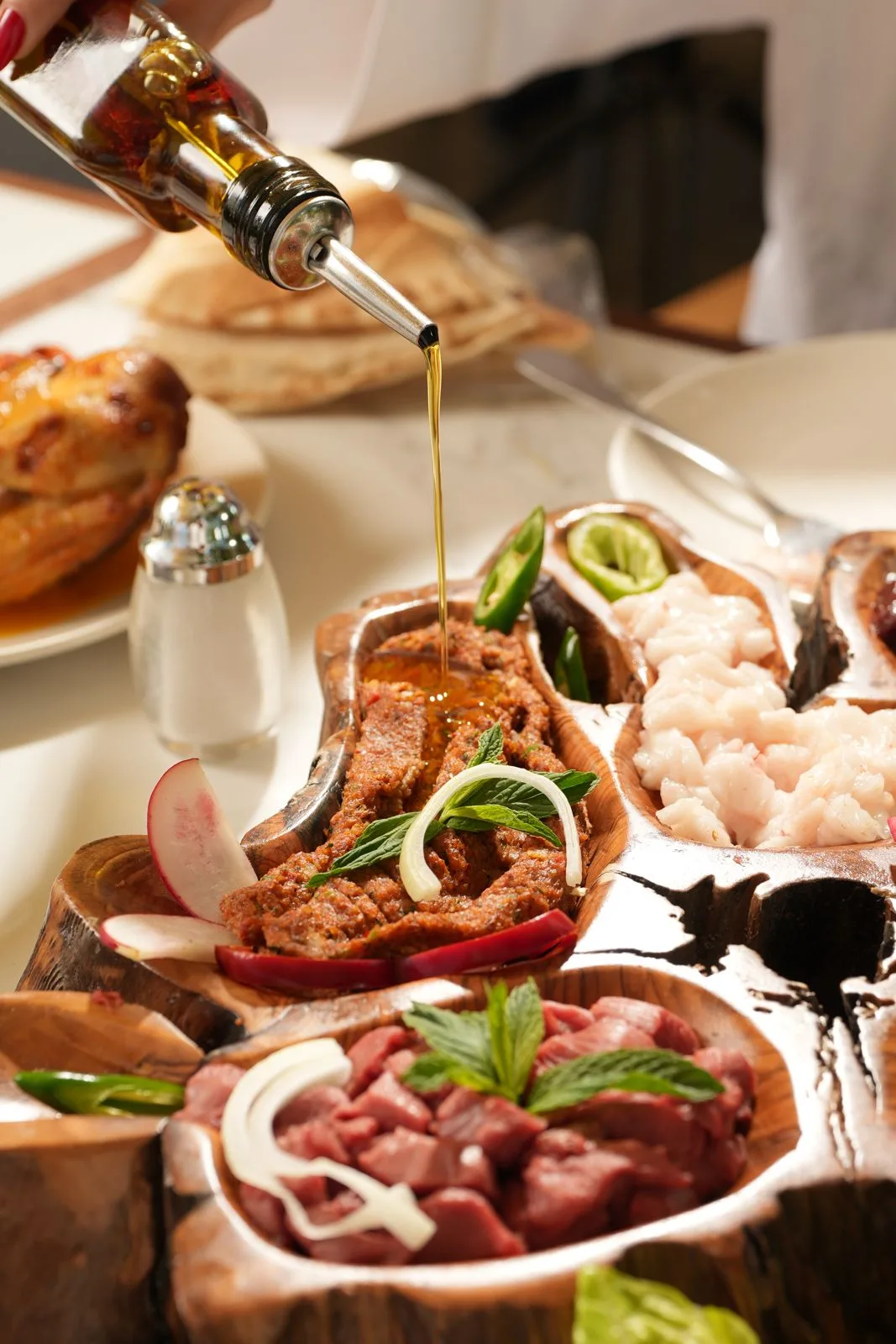 Olive oil drizzled over a mezze spread