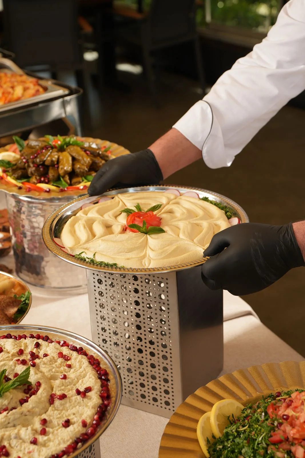 Chef arranging a mezze buffet