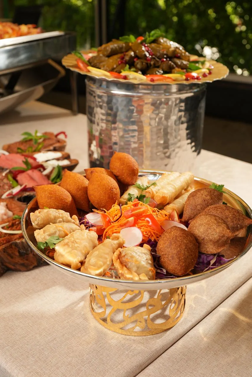 Kibbeh and mezze on a silver stand